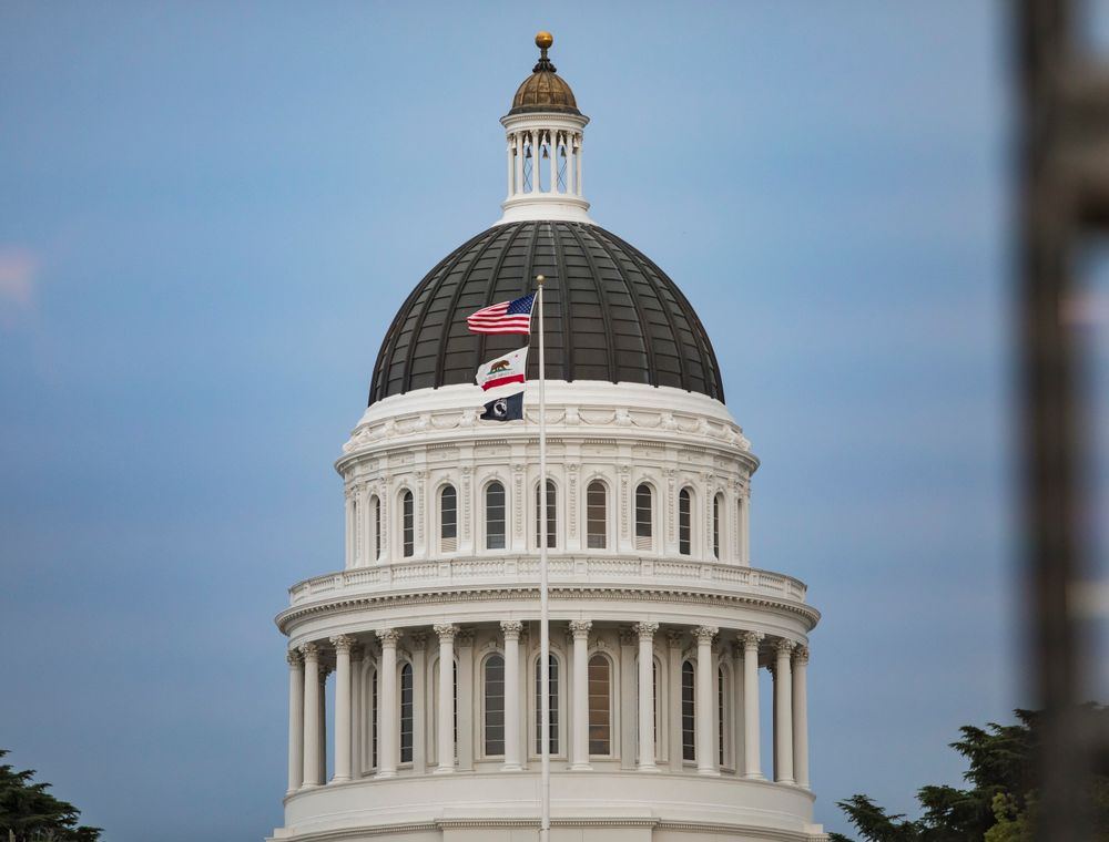 California State Capitol dome with American and state flags