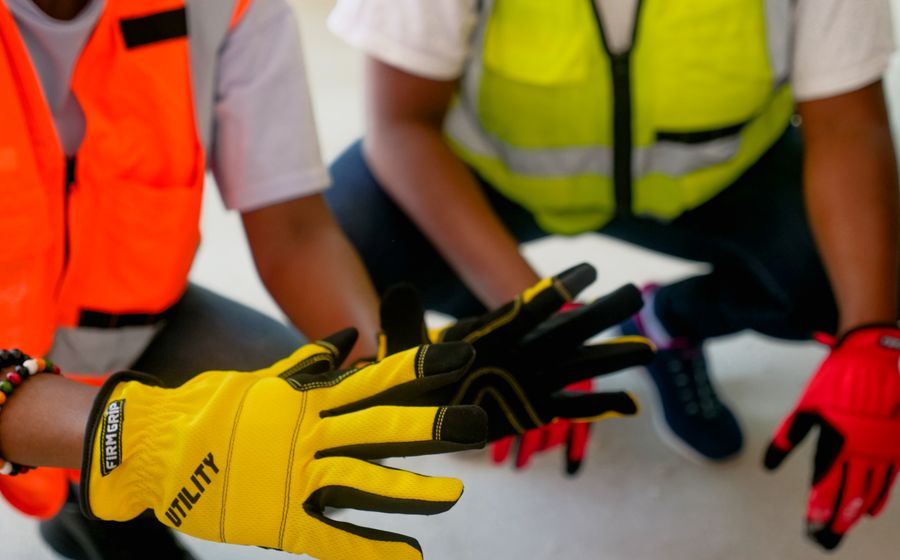 Workers wearing protective gloves and high visibility safety vests