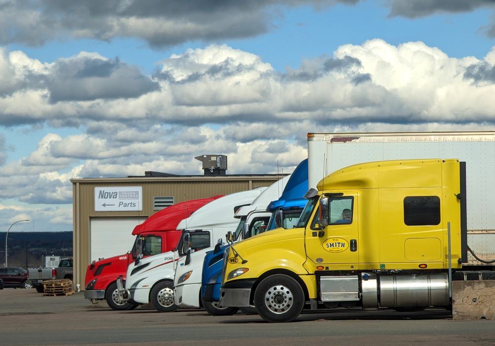 Fleet of delivery trucks staged outside a warehouse